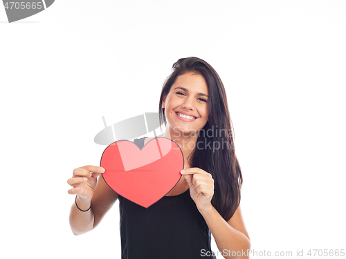 Image of beautiful happy young woman who is holding a big red heart for v