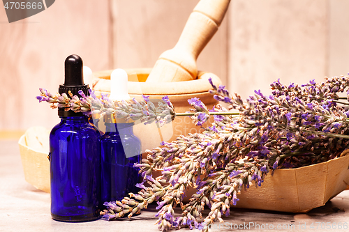 Image of lavender mortar and pestle and bottles of essential oils for aro