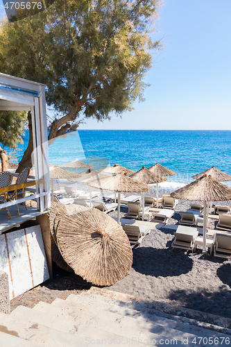 Image of restaurant terrace in front of the beach in kamari on the island