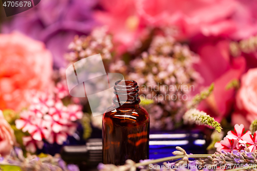 Image of flowers and bottles of essential oils for aromatherapy