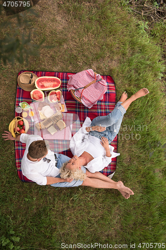 Image of top view of couple enjoying picnic time