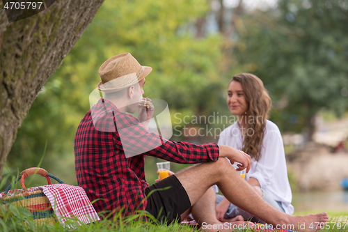 Image of Couple in love enjoying picnic time