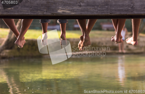 Image of people sitting at wooden bridge