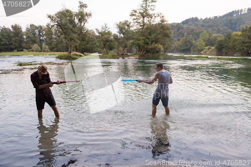 Image of young men having fun with water guns