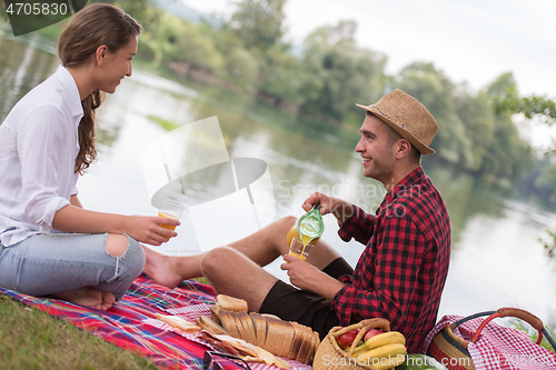 Image of Couple in love enjoying picnic time