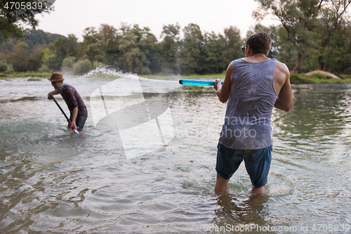 Image of young men having fun with water guns