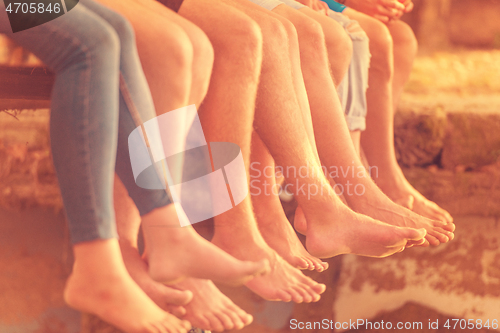 Image of people sitting at wooden bridge