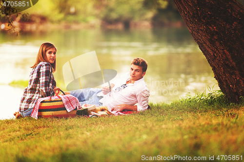 Image of Couple in love enjoying picnic time