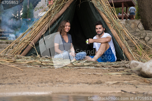 Image of couple spending time together in straw tent