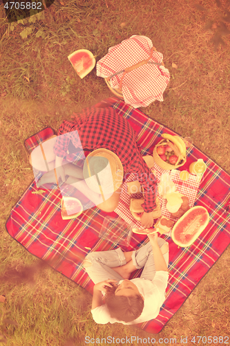 Image of top view of couple enjoying picnic time