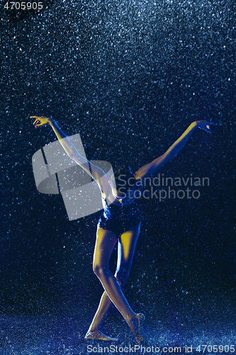 Image of Two young female ballet dancers under water drops