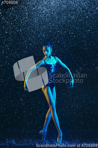 Image of Two young female ballet dancers under water drops