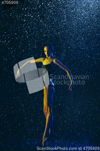 Image of Two young female ballet dancers under water drops