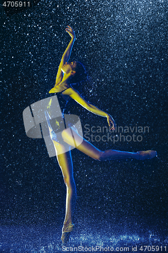 Image of Two young female ballet dancers under water drops