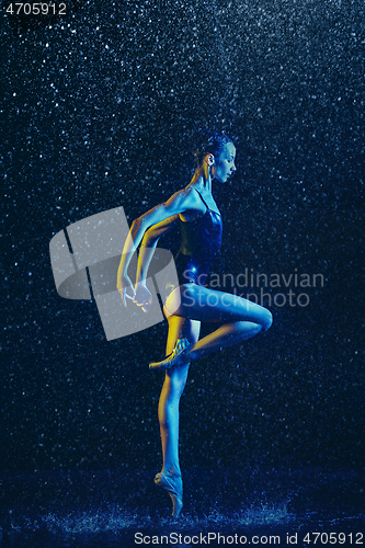 Image of Two young female ballet dancers under water drops