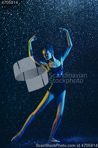 Image of Two young female ballet dancers under water drops