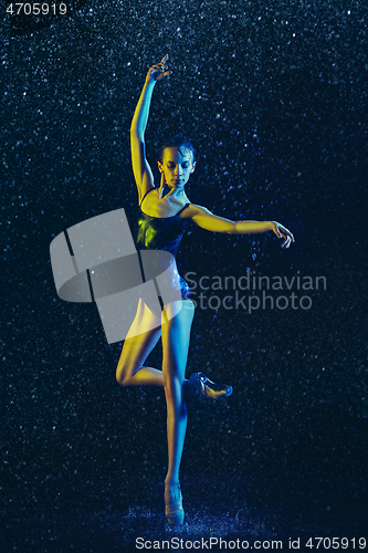 Image of Two young female ballet dancers under water drops