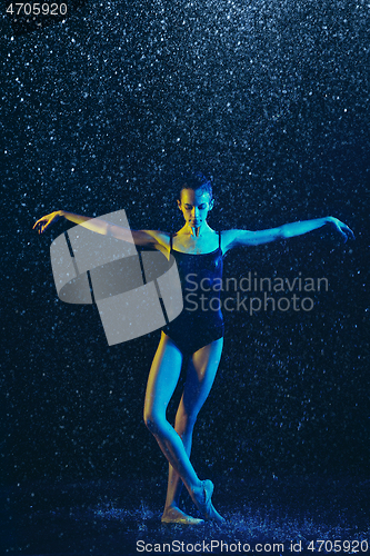 Image of Two young female ballet dancers under water drops