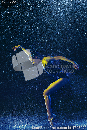 Image of Two young female ballet dancers under water drops