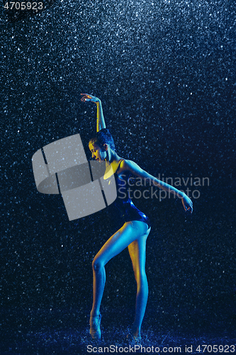 Image of Two young female ballet dancers under water drops