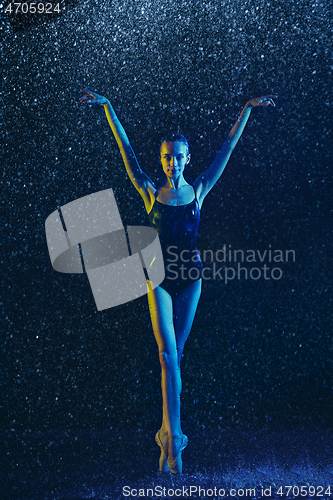 Image of Two young female ballet dancers under water drops