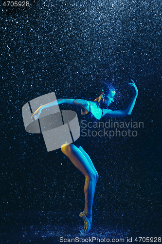Image of Two young female ballet dancers under water drops