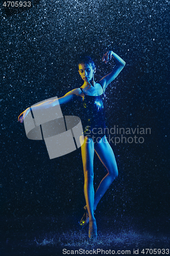 Image of Two young female ballet dancers under water drops