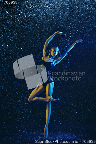 Image of Two young female ballet dancers under water drops