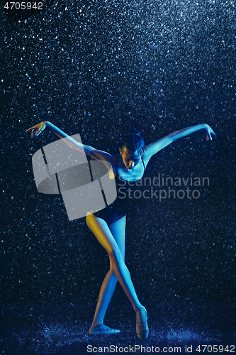 Image of Two young female ballet dancers under water drops