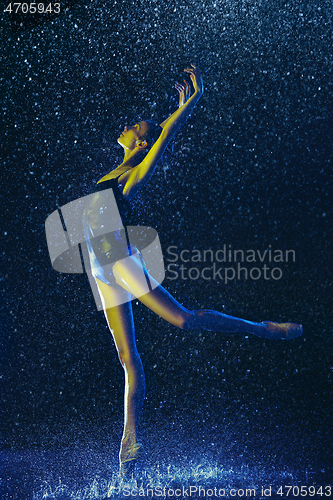 Image of Two young female ballet dancers under water drops