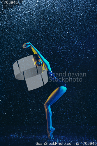 Image of Two young female ballet dancers under water drops