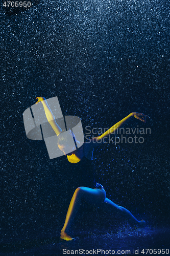 Image of Two young female ballet dancers under water drops