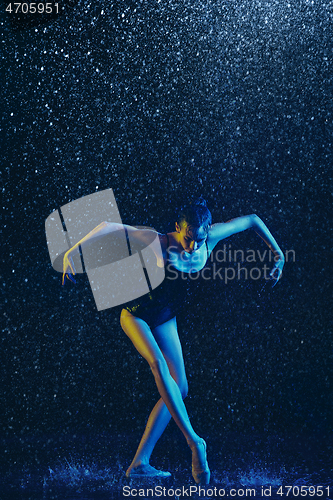 Image of Two young female ballet dancers under water drops