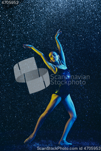 Image of Two young female ballet dancers under water drops