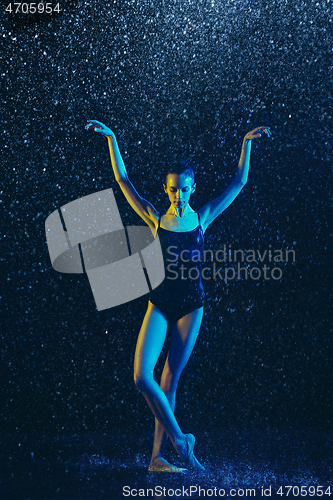 Image of Two young female ballet dancers under water drops