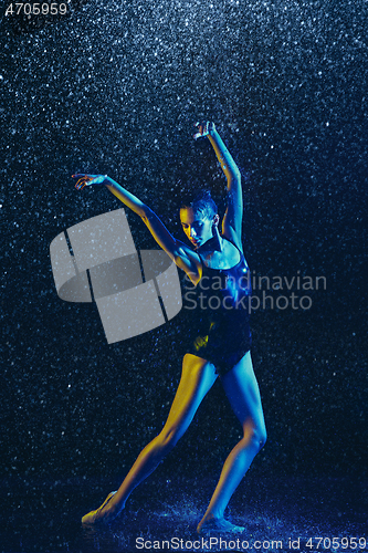 Image of Two young female ballet dancers under water drops