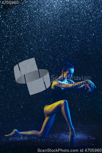 Image of Two young female ballet dancers under water drops