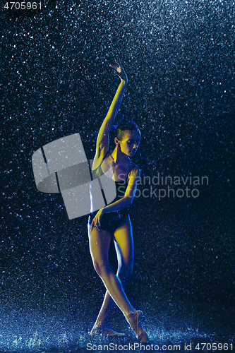 Image of Two young female ballet dancers under water drops