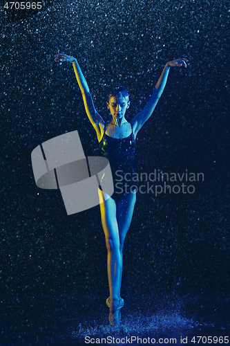 Image of Two young female ballet dancers under water drops