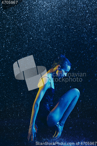 Image of Two young female ballet dancers under water drops