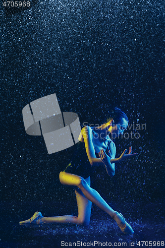Image of Two young female ballet dancers under water drops