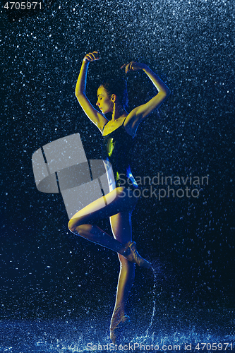 Image of Two young female ballet dancers under water drops