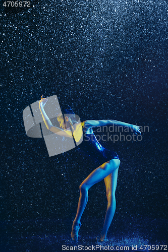 Image of Two young female ballet dancers under water drops
