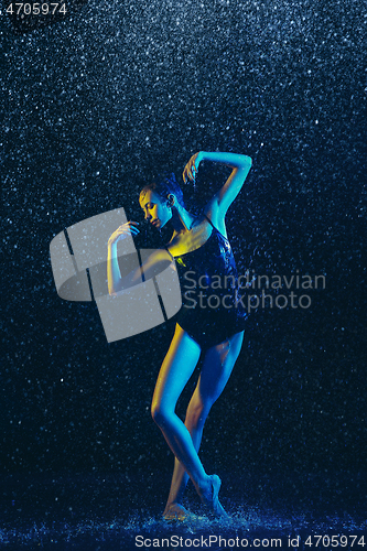 Image of Two young female ballet dancers under water drops