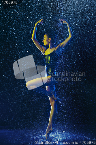 Image of Two young female ballet dancers under water drops