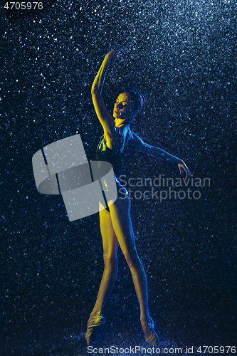 Image of Two young female ballet dancers under water drops