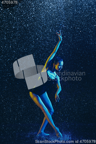 Image of Two young female ballet dancers under water drops