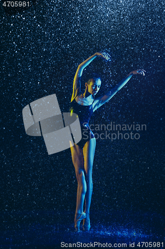 Image of Two young female ballet dancers under water drops