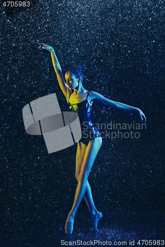 Image of Two young female ballet dancers under water drops