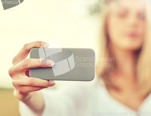 Image of close up of woman taking selfie by smartphone